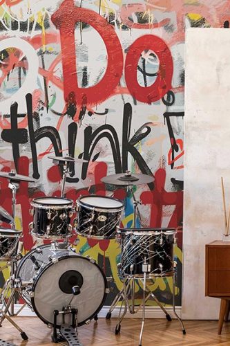 Graffiti style seamless wall mural with abstract graphic and texts in modern game room interior with musical instruments. Fancy Walls wallpaper peel and stick or non-pasted