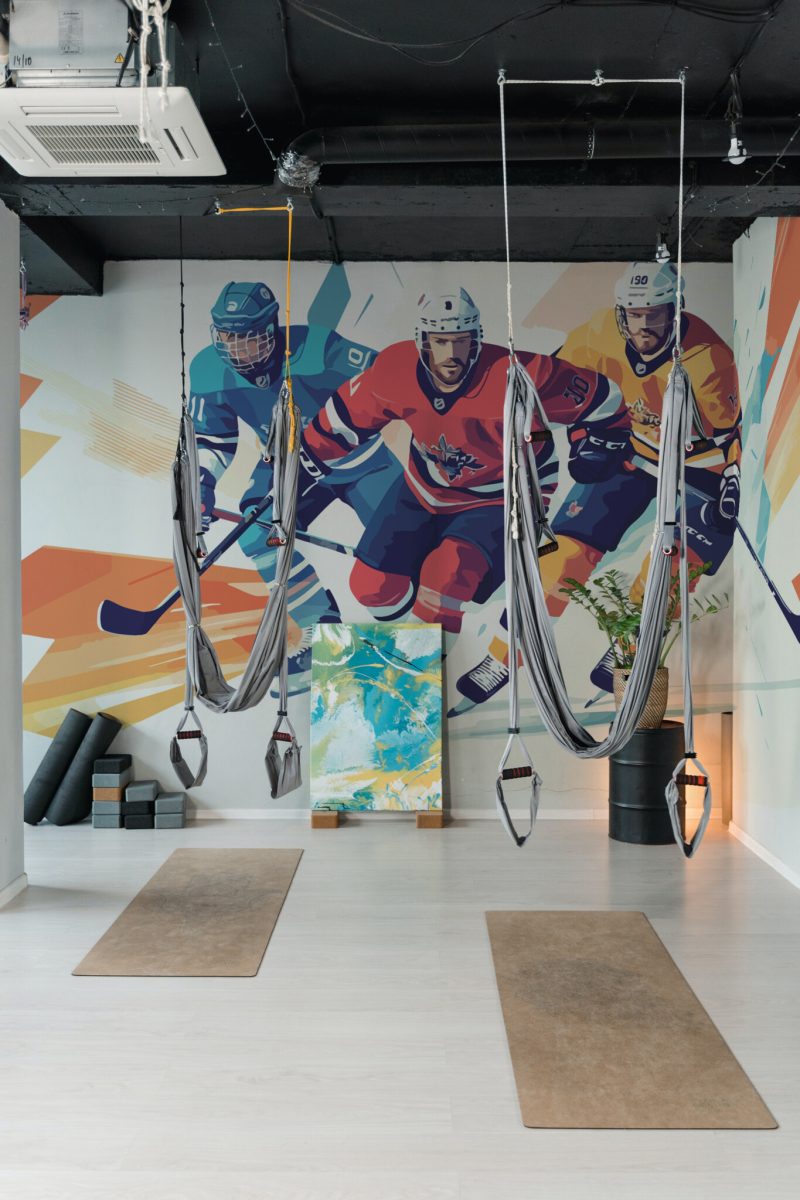 Abstract Art Hockey Players Wall Mural with three colorful hockey figures on an abstract background, ideal for gyms, game rooms, and sporty interiors.