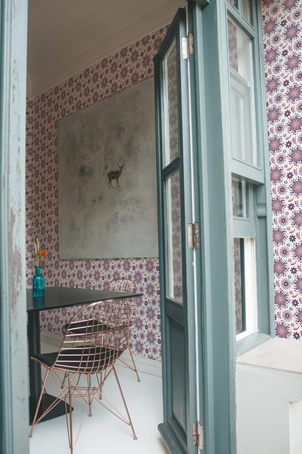 Minimal coastal style cafe decorated with 4th july peel and stick wallpaper