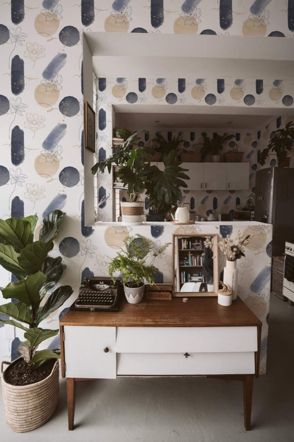 Boho style living room and kitchen decorated with Abstract Brush stroke floral peel and stick wallpaper and green plants