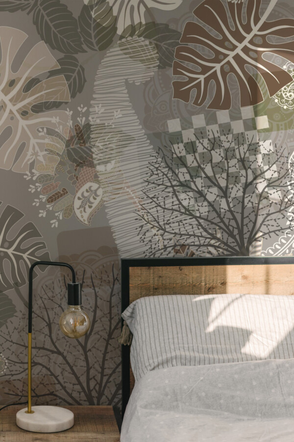 Peel and stick wall murals featuring abstract tropical leaf shapes with intricate paisley details in earthy grays, browns, and greens, ideal for bedrooms and cozy interiors. The Fancy Walls peel and stick or non-pasted wallpaper.