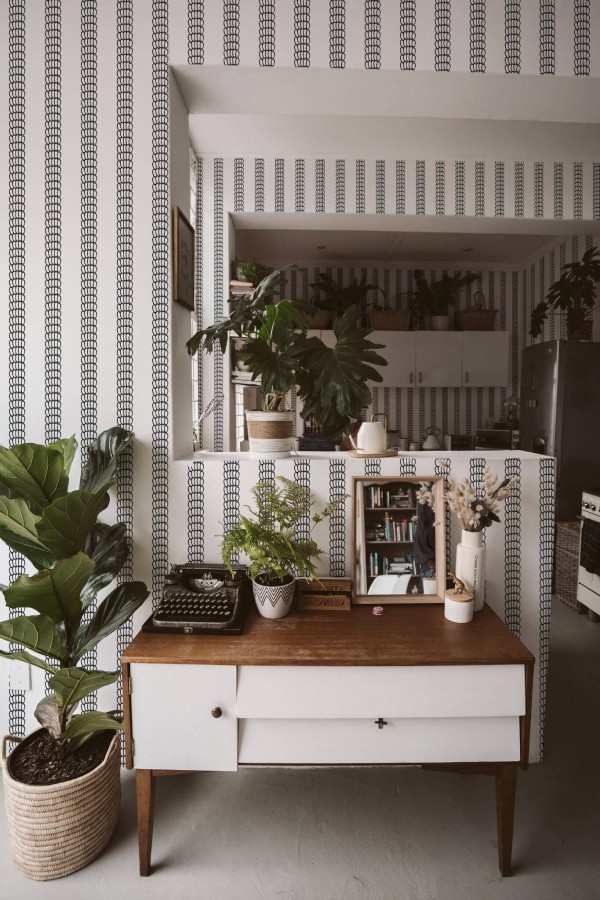 Boho style living room and kitchen decorated with Abstract stripes peel and stick wallpaper and green plants