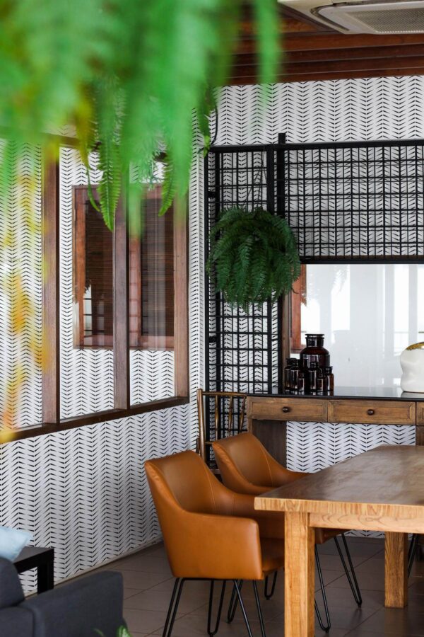 Mid-century modern style dining room decorated with Accent herringbone peel and stick wallpaper and black industrial accents