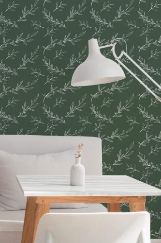 A green botanical wallpaper featuring delicate white line-art leaves arranged in a flowing, repeat pattern, adding organic movement and calm to the setting. The leafy design complements the minimalist white dining area, styled with a modern marble-top table, wooden legs, a soft gray couch, and a sculptural floor lamp. The Fancy Walls peel and stick or non-pasted wallpaper enhances modern café or home office interiors with its clean, nature-inspired aesthetic and calming color palette.