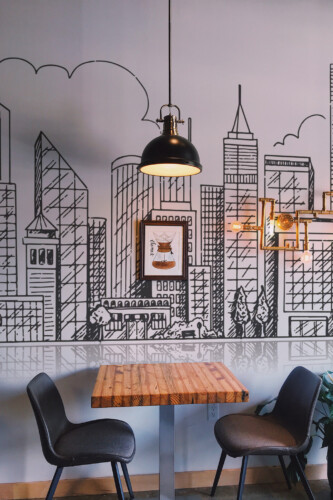 Peel and stick wall murals featuring hand-drawn city buildings in linear style with reflective skyline effect in black and white. The Fancy Walls peel and stick or non-pasted wallpaper.
