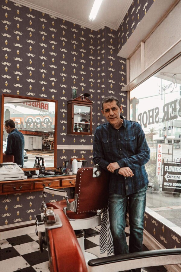 Mid-century style barber shop decorated with Barber shop vintage peel and stick wallpaper