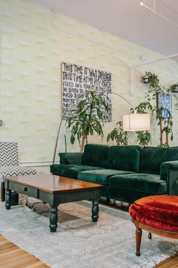 Bold eclectic style living room decorated with Beige marine peel and stick wallpaper and emerald green sofa