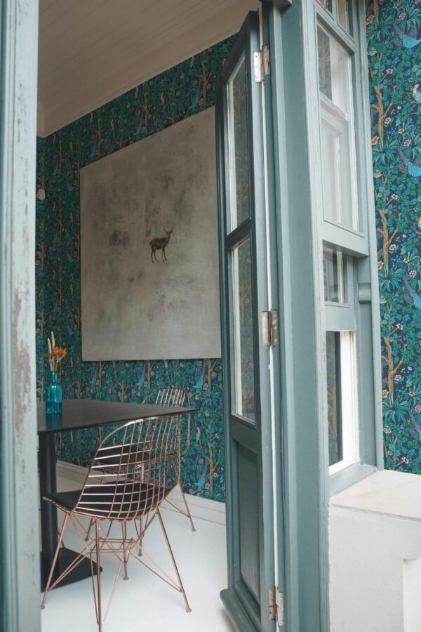 Minimal coastal style cafe decorated with Bird forest peel and stick wallpaper