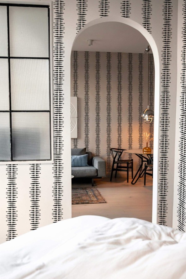 Modern scandinavian style living room decorated with Black and white boho stripe peel and stick wallpaper