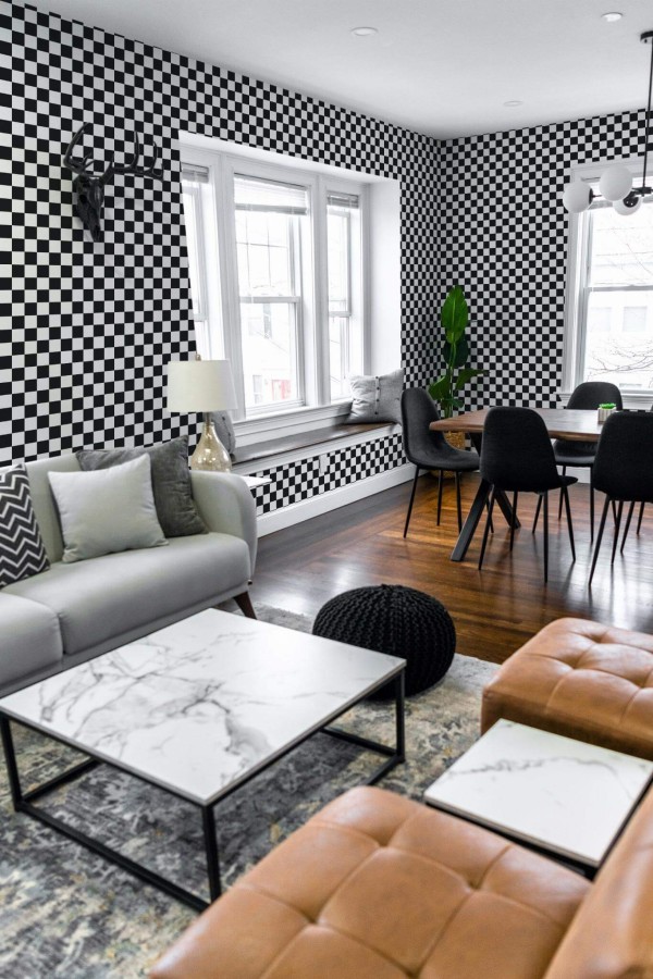 Mid-century modern scandinavian style living dining room decorated with Black and white checkered peel and stick wallpaper
