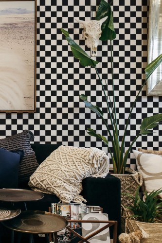 Living room with black and white check wallpaper styled behind sofa in farmhouse interior
