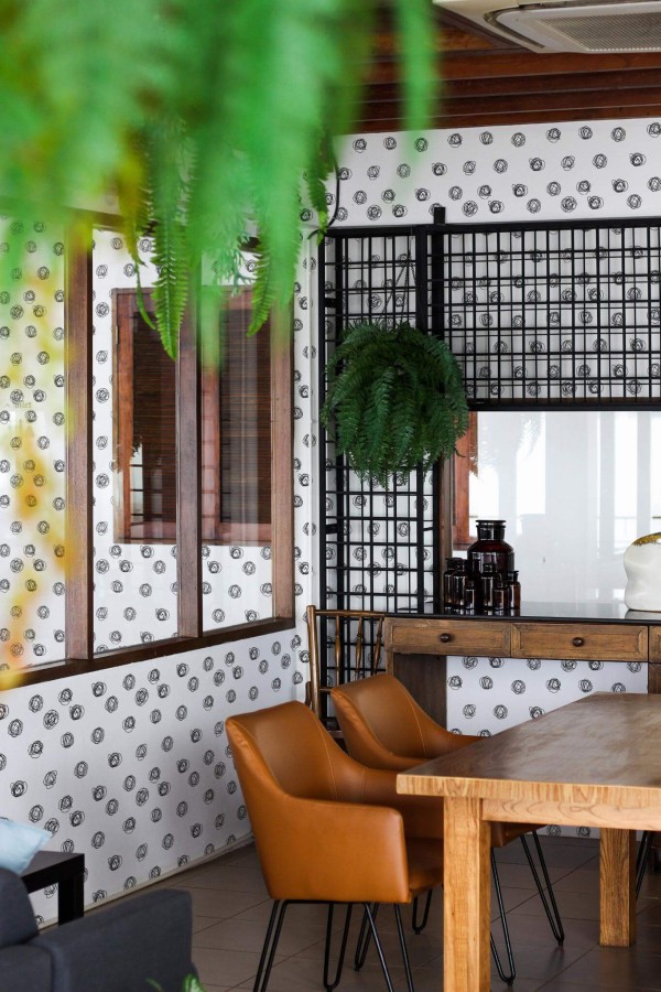 Mid-century modern style dining room decorated with Black and white dot peel and stick wallpaper and black industrial accents