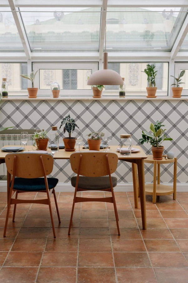 MId-century modern style dining room on a balcony decorated with Black and white plaid peel and stick wallpaper