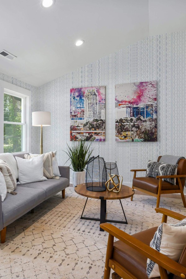 Mid-century modern style living room decorated with Blue and white delicate retro peel and stick wallpaper and colorful funky artwork