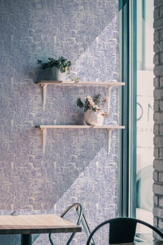 Industrial style cafe decorated with Blue ink peel and stick wallpaper