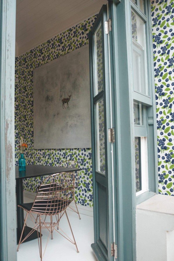 Minimal coastal style cafe decorated with Blueberry peel and stick wallpaper