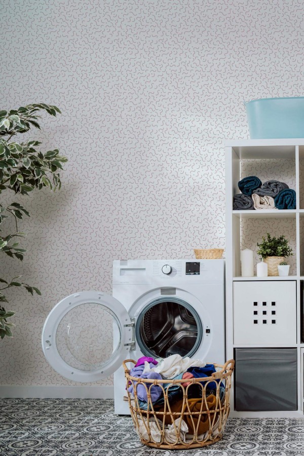 Minimal scandinavian style laundry room decorated with Blush memphis pattern peel and stick wallpaper