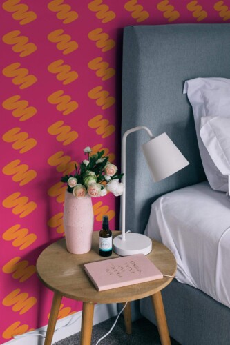 Rustic style bedroom decorated with Bright pink and orange peel and stick wallpaper