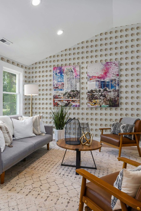 Mid-century modern style living room decorated with Brown and beige circular peel and stick wallpaper and colorful funky artwork