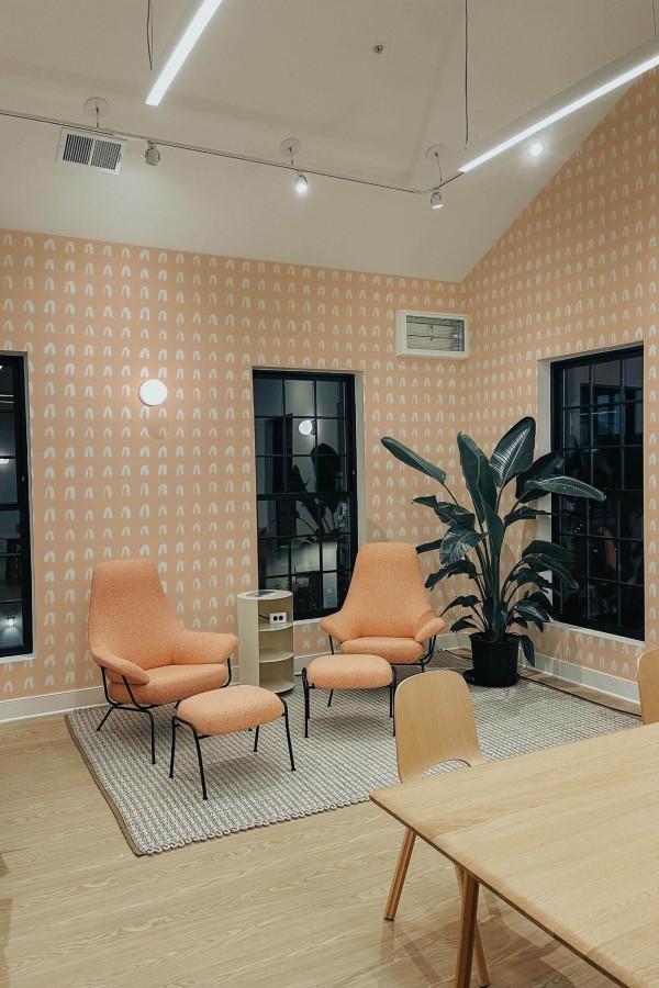 Minimal style living room decorated with Brush stroke arch peel and stick wallpaper and mid-century style chairs