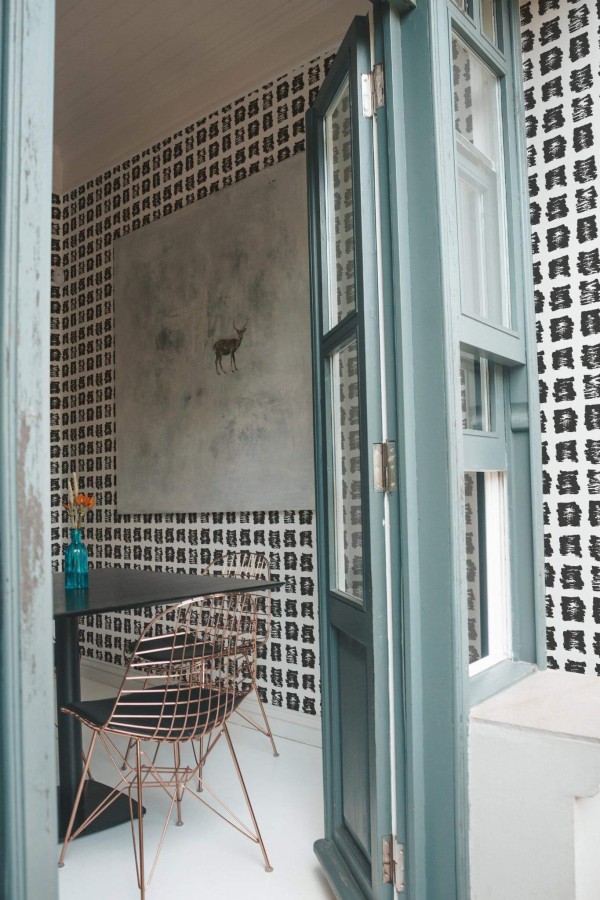 Minimal coastal style cafe decorated with Brush stroke mosaic peel and stick wallpaper