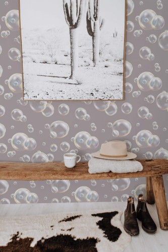 Realistic floating bubble wallpaper with a subtle gray background, displayed in a cozy entryway featuring a wooden bench, southwestern cactus print, boots, and warm neutral accents. The design adds whimsical charm while maintaining a modern, sophisticated feel.