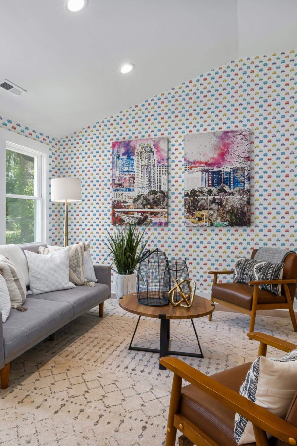 Mid-century modern style living room decorated with Cars peel and stick wallpaper and colorful funky artwork