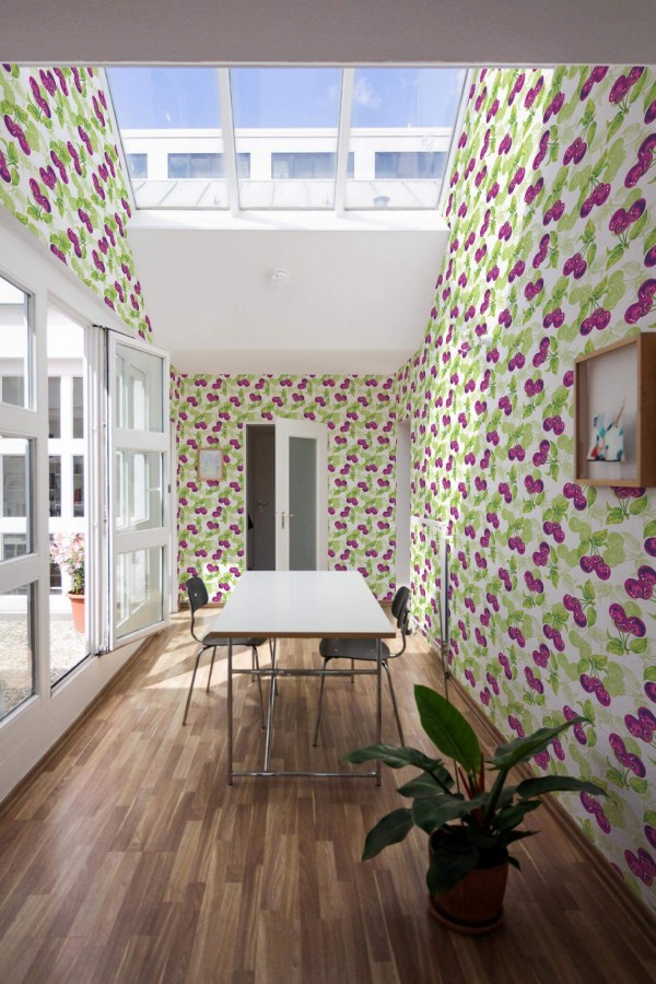 Minimal style dining room next to a balcony decorated with Cherry peel and stick wallpaper