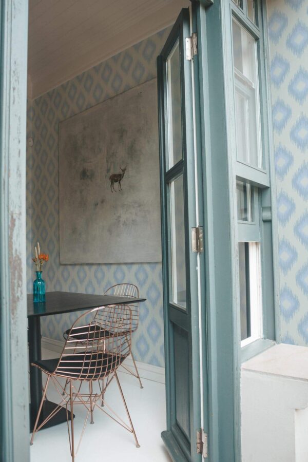 Minimal coastal style cafe decorated with Coastal ikat peel and stick wallpaper