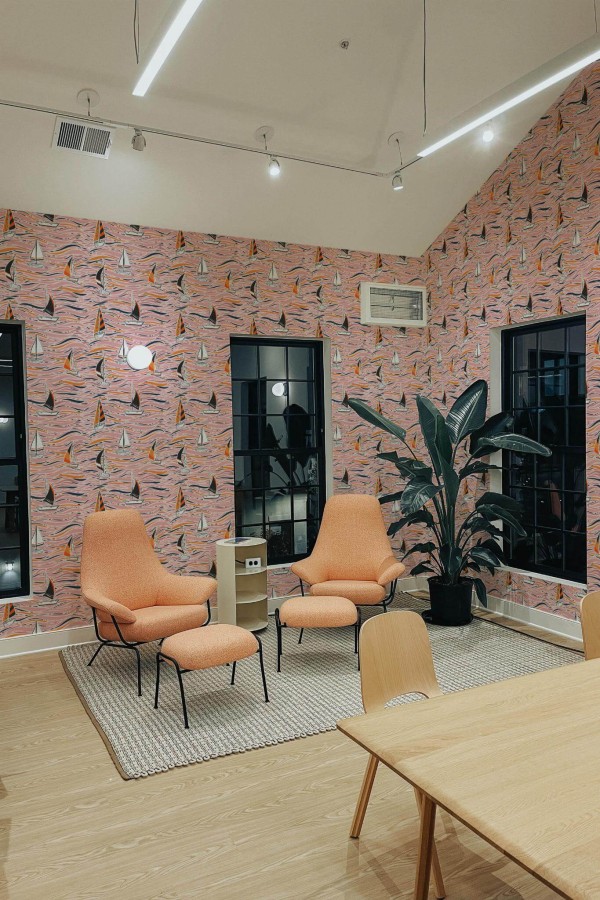 Minimal style living room decorated with Colorful boat peel and stick wallpaper and mid-century style chairs