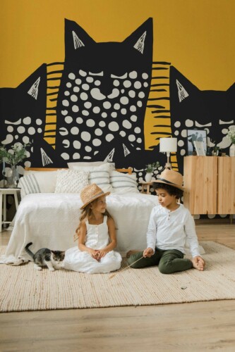 Playful Cat peel and stick or non-pasted wall mural. Novelty animal mural wallpaper with stylized black and white cats on orange background for accent wall design.