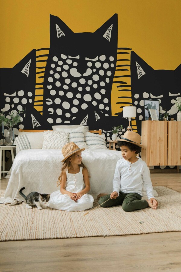 Playful Cat peel and stick or non-pasted wall mural. Novelty animal mural wallpaper with stylized black and white cats on orange background for accent wall design.