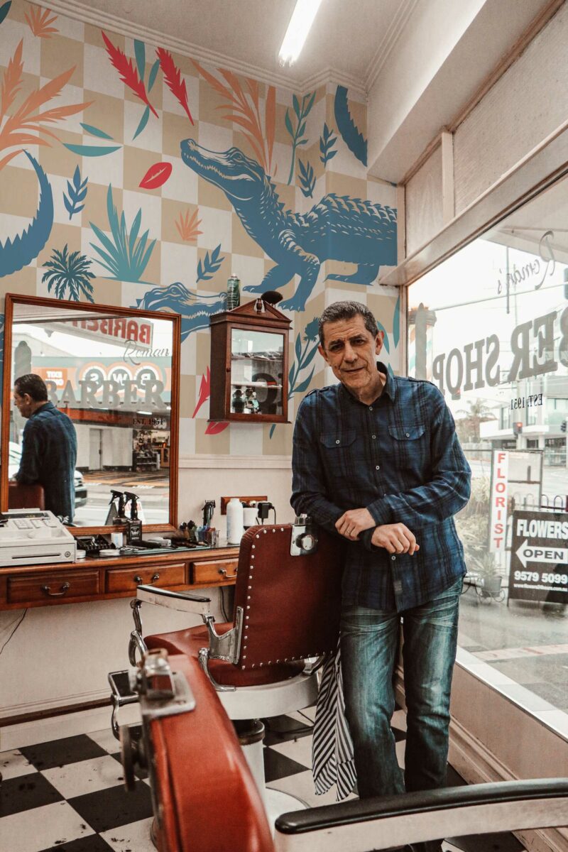 Colorful Crocodile wall mural with blue and beige checkered design, floral accents, and tropical animals, perfect for barber shops or playful accent walls.