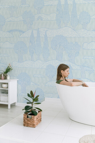 Tranquil Trees Wall Mural with soft blue tree silhouettes on a light blue background, perfect for bathrooms, spa-like interiors, or calming accent walls.