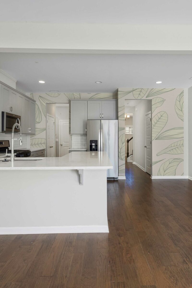 Calming Kitchen Leaves Wall Mural with light green leaf patterns on a soft beige background, perfect for kitchens, dining areas, or cozy breakfast corners.