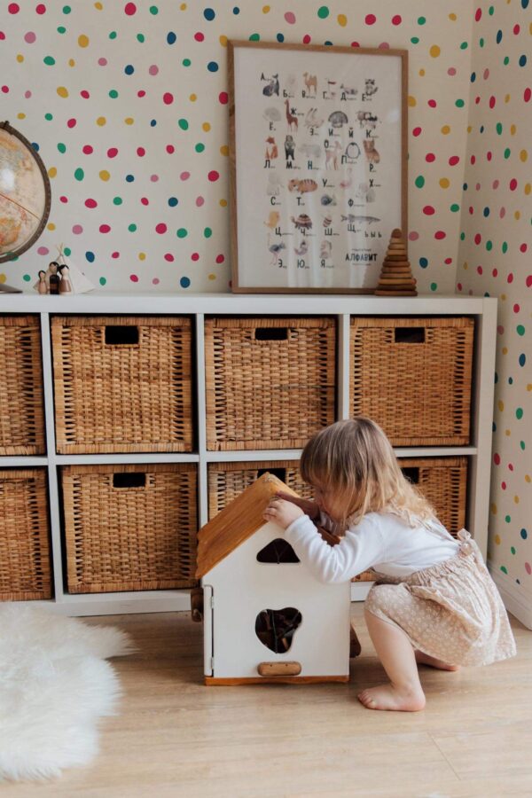Boho gender neutral style kids room decorated with Colorful polka dot peel and stick wallpaper