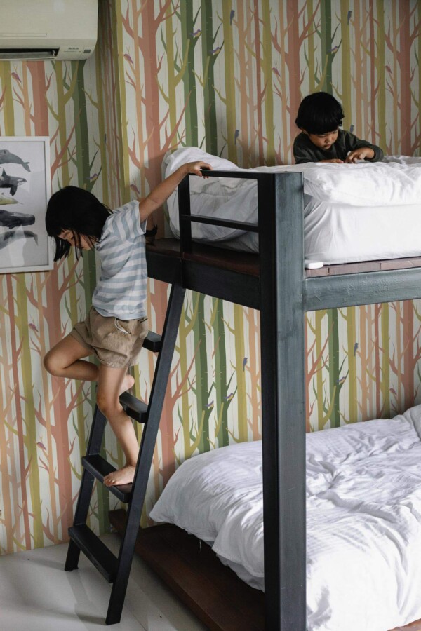 Minimalistic style kids room decorated with Colorful trees peel and stick wallpaper