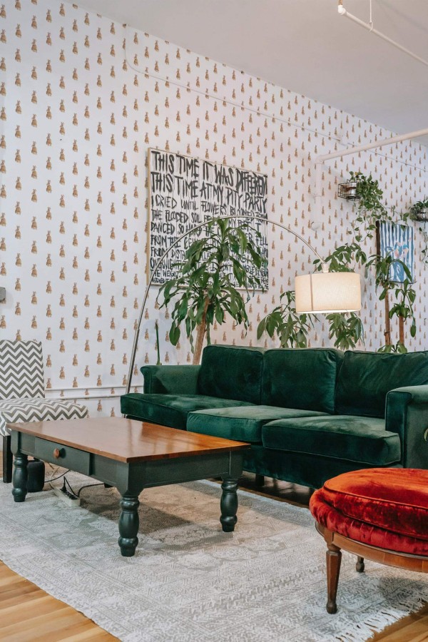 Bold eclectic style living room decorated with Cute Bunny peel and stick wallpaper and emerald green sofa