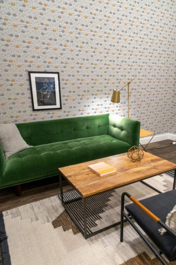Mid-century modern living room decorated with Cute Cat peel and stick wallpaper and forest green sofa