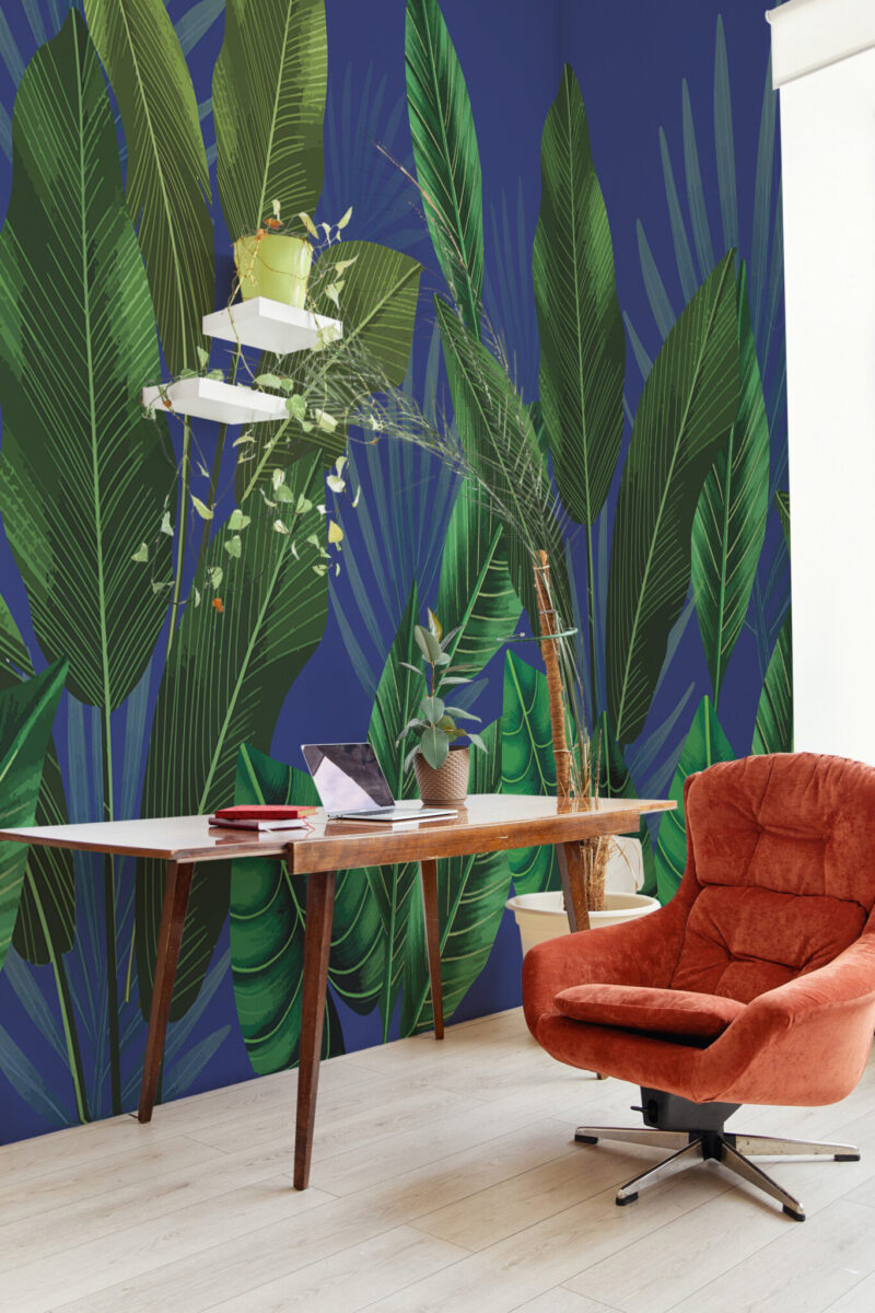 Tropic Dream Wall Mural with lush green tropical leaves on a dark blue background, perfect for office walls, workspaces, or bold accent interiors.