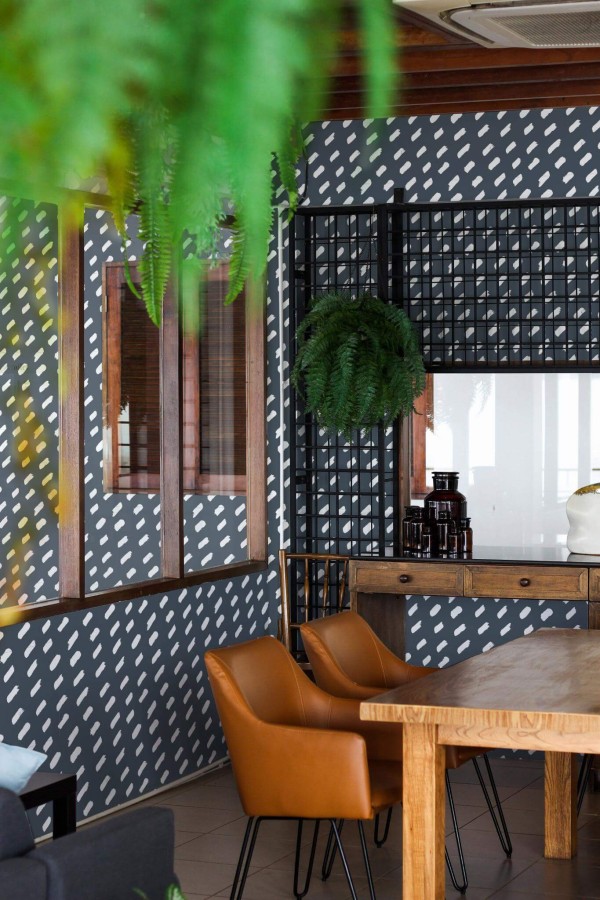 Mid-century modern style dining room decorated with Diagonal Brush stroke peel and stick wallpaper and black industrial accents
