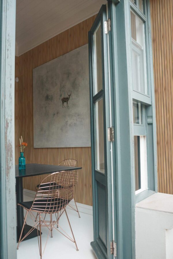 Minimal coastal style cafe decorated with Faux wooden slats peel and stick wallpaper