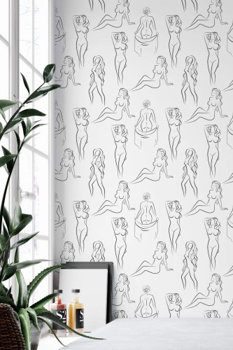 Female line art peel and stick wallpaper with black nude sketches on white, styled in a bright modern room with indoor plants.