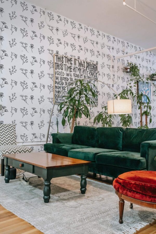 Bold eclectic style living room decorated with Flower peel and stick wallpaper and emerald green sofa
