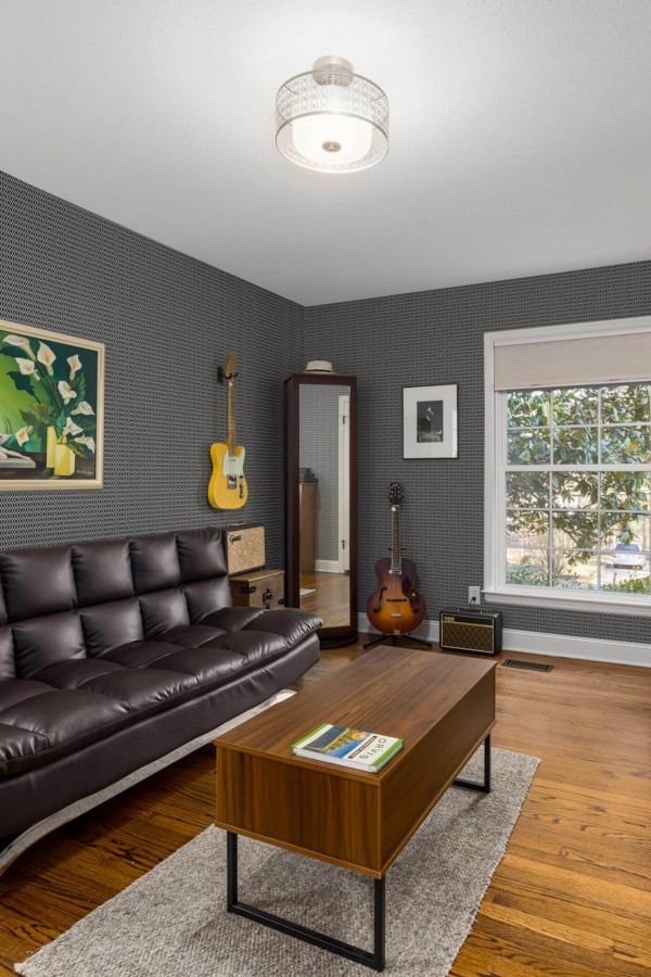 Mid-century style living room decorated with Geometric Harlequin peel and stick wallpaper and music instruments