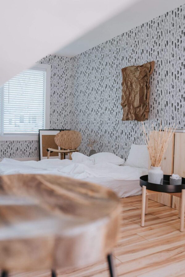 Boho style bedroom decorated with Gray Brush stroke peel and stick wallpaper