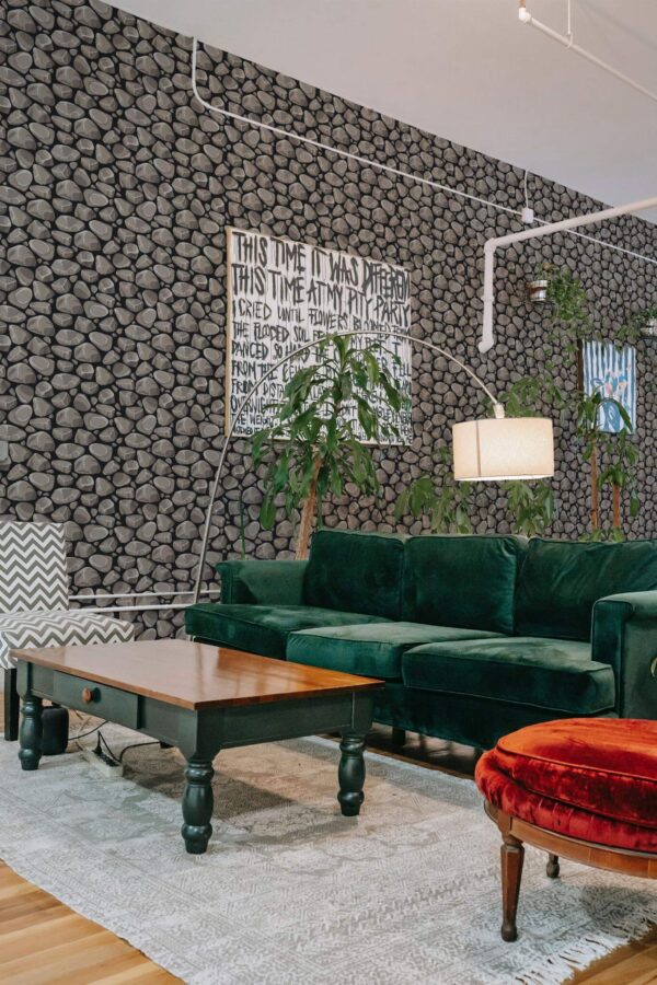 Bold eclectic style living room decorated with Gray Stone peel and stick wallpaper and emerald green sofa