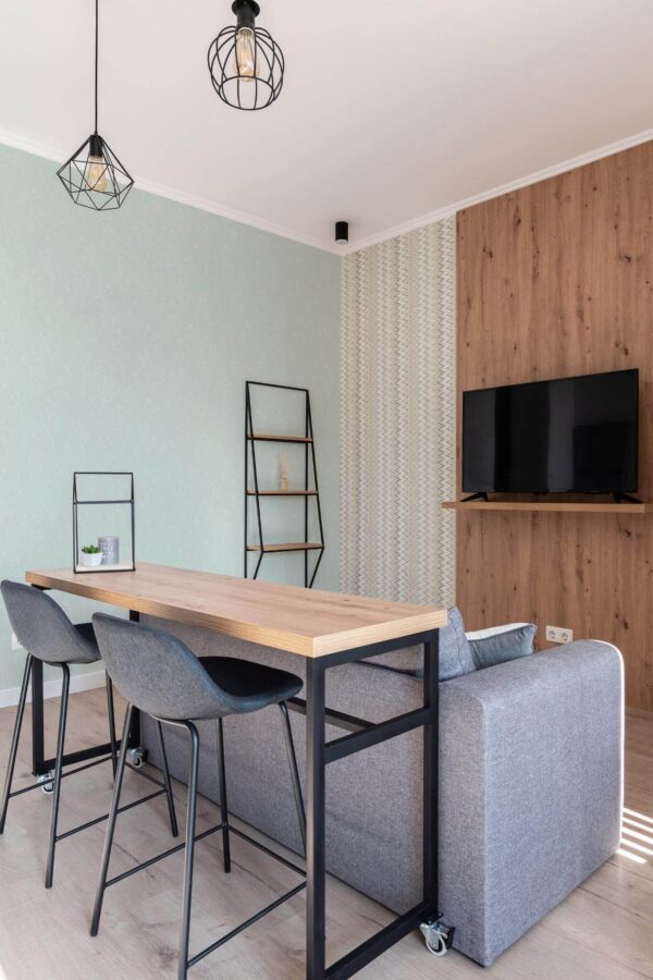 Scandinavian style open living room decorated with Green branch peel and stick wallpaper