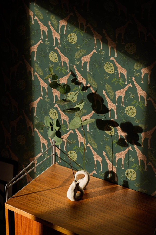 This green wallpaper features playful giraffes amidst tropical foliage, creating a jungle-inspired design that brings nature into your space. The repeating pattern of giraffes with spotted coats and lush plants in shades of green and mustard yellow adds a touch of whimsy and elegance to any room. Ideal for living rooms, nurseries, or kids’ rooms, this design creates a soothing yet exciting atmosphere. The Fancy Walls peel and stick or non-pasted wallpaper is made from eco-friendly, PVC-free materials, printed with GreenGuard Gold certified inks for vibrant, long-lasting color and indoor air quality.