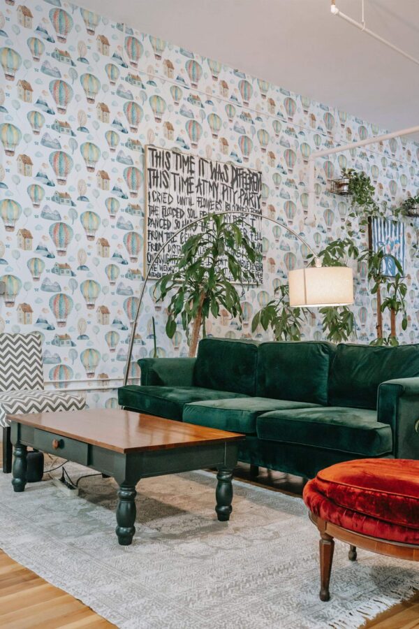 Bold eclectic style living room decorated with Hot air balloon nursery peel and stick wallpaper and emerald green sofa